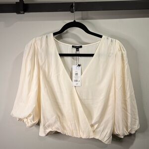 BNWT Brand new with tags, never worn. Dynamite cropped wrap blouse. Size small